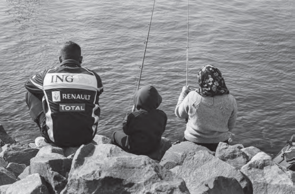 Balck and white photo of a family fishing in South Africa
