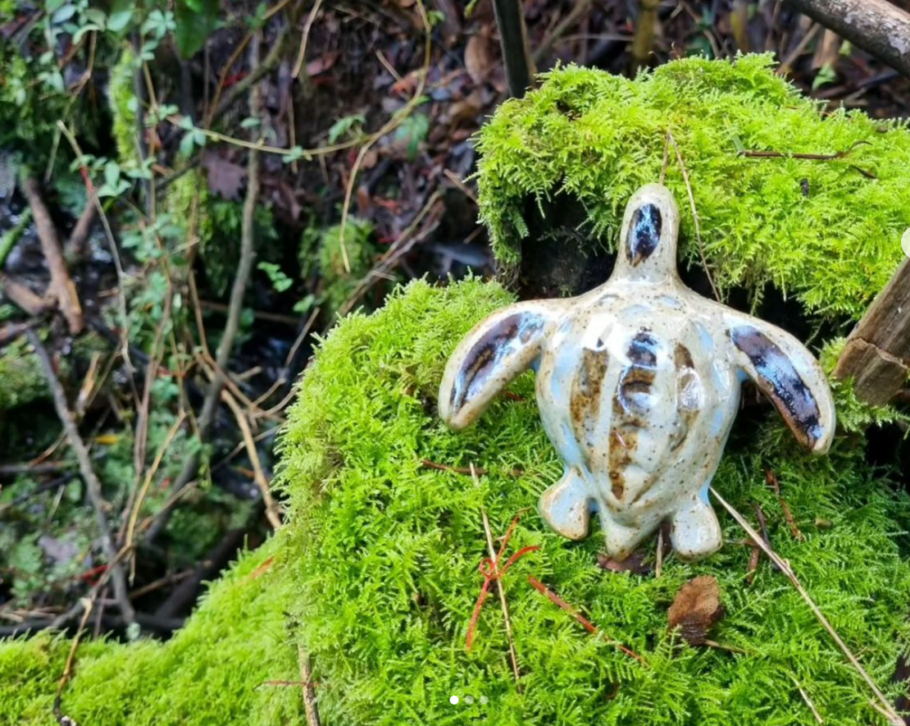 Ceramic turtle against a background of moss
